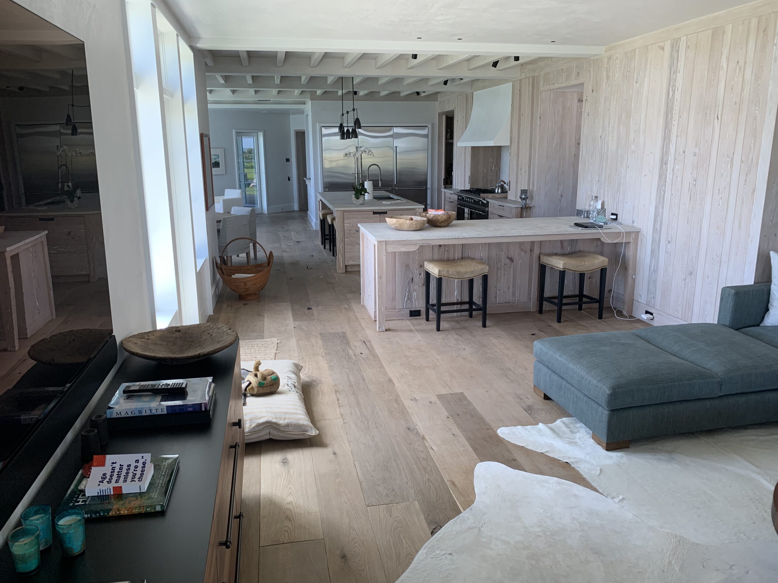 Wide plank hardwood flooring arranged through an open residential interior