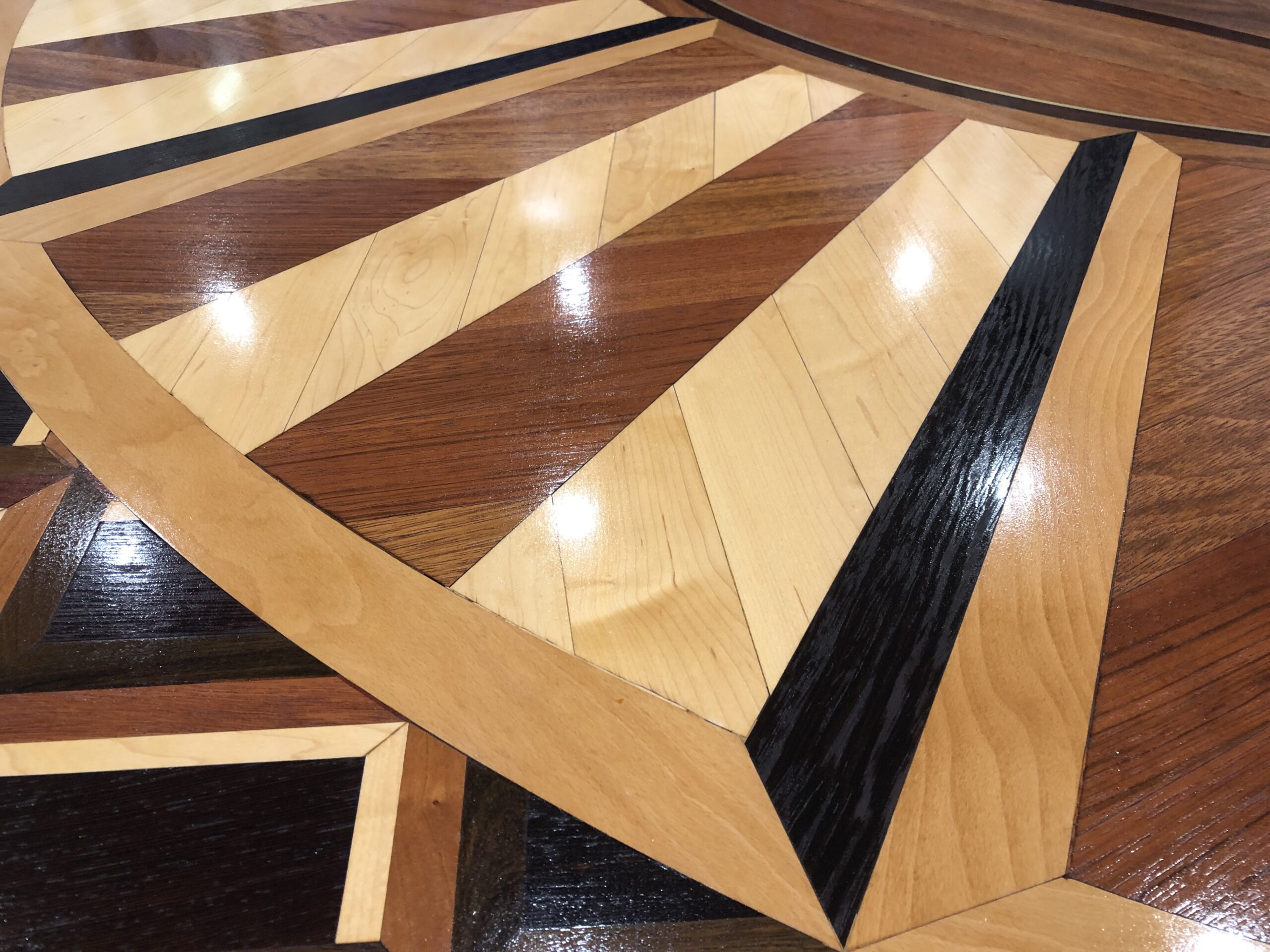 Close view of precise custom hardwood marquetry using contrasting wood species