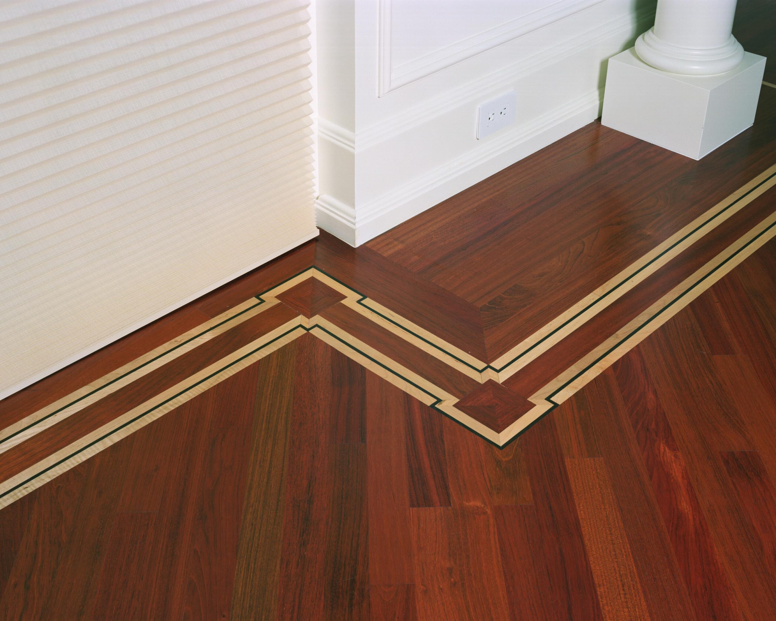 Decorative hardwood border fitted precisely around an architectural corner