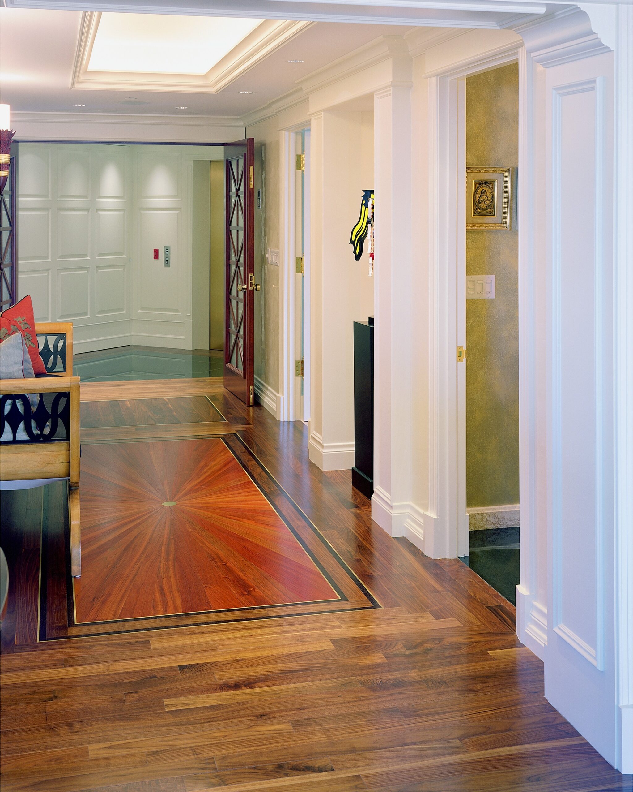 Completed hardwood hallway with a decorative border by Endurance Floor Company