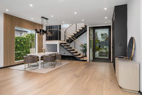 Finished hardwood stairs coordinated with wide plank flooring by Endurance Floor Company