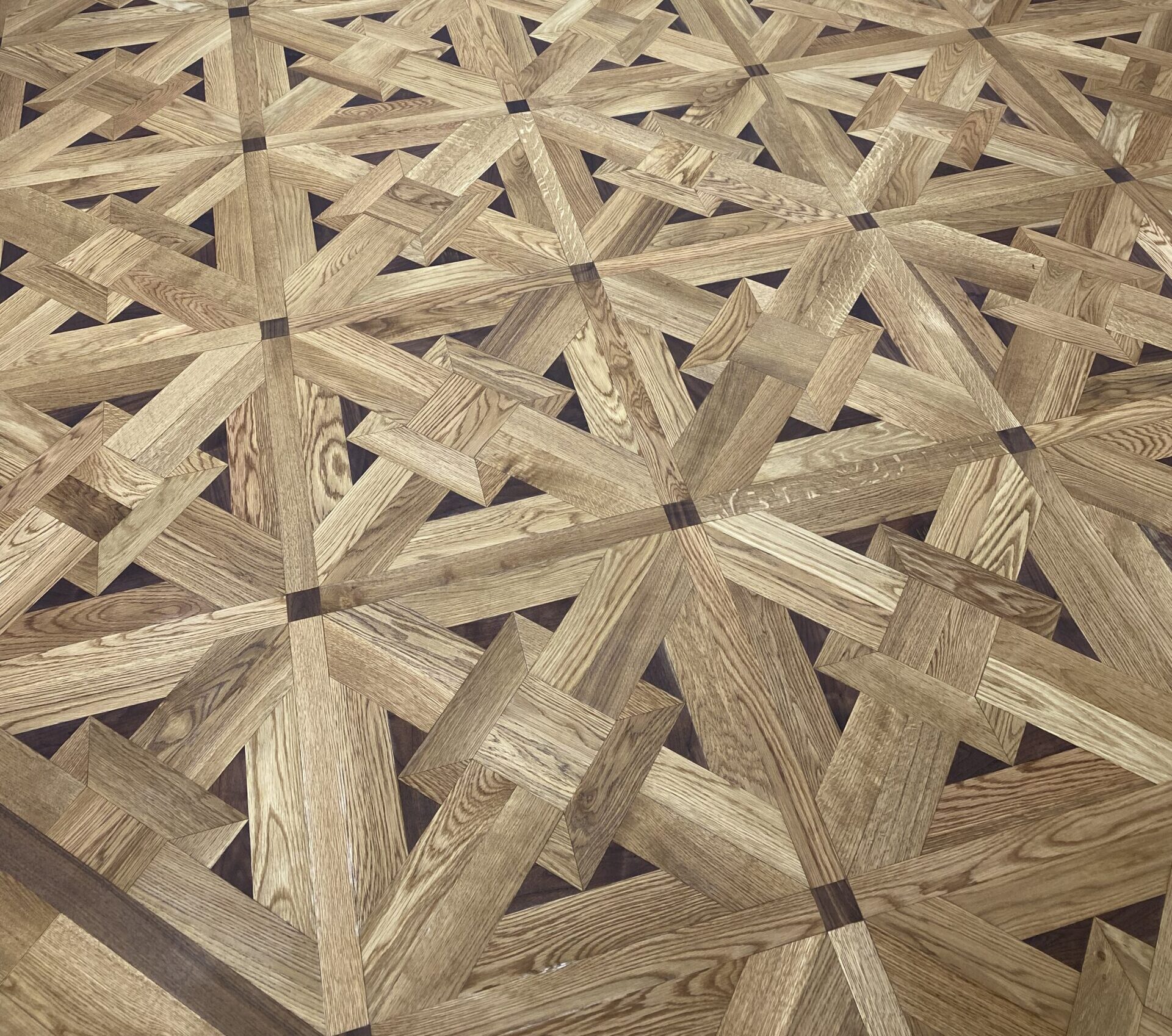 Large circular custom hardwood floor medallion inside an architectural interior