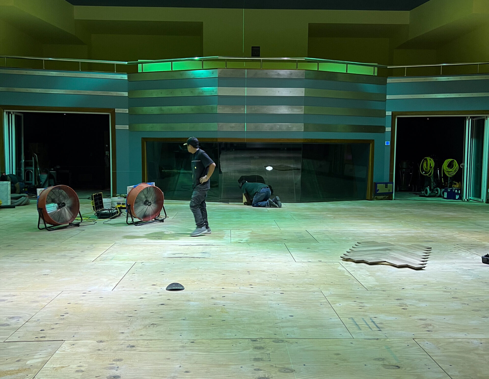 Endurance Floor Company craftspeople assembling a radial hardwood floor design in the West Park workshop