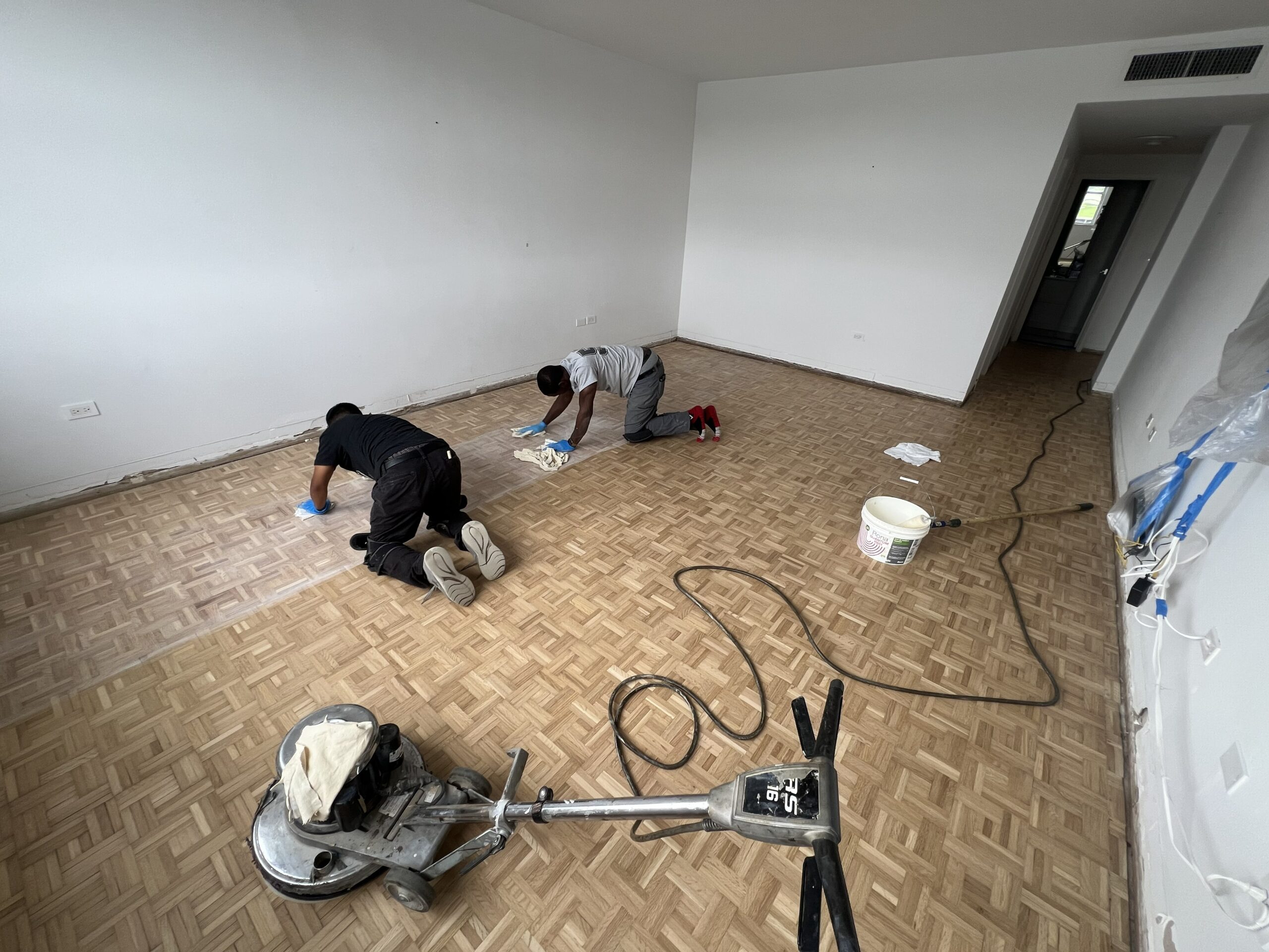 Refinished hardwood floor with a contrasting border and corner detail